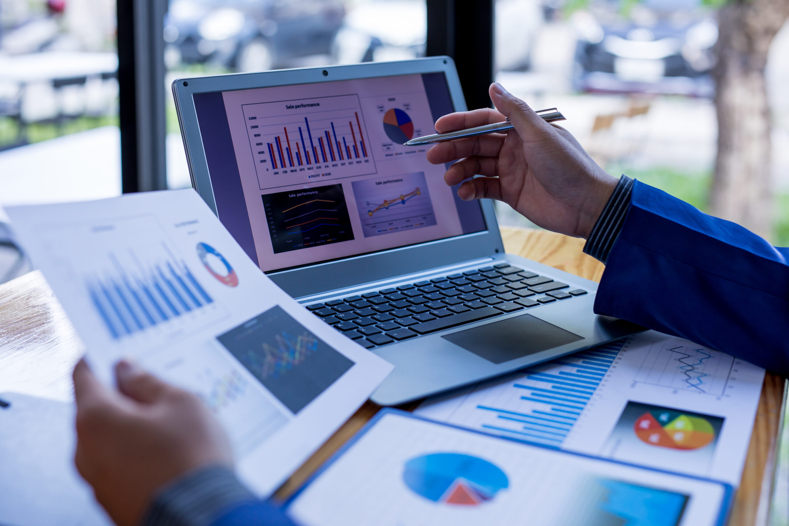 Financial Businessman analyze the graph of the company's performance to create profits and growth, Market research reports and income statistics, Financial and Accounting concept.